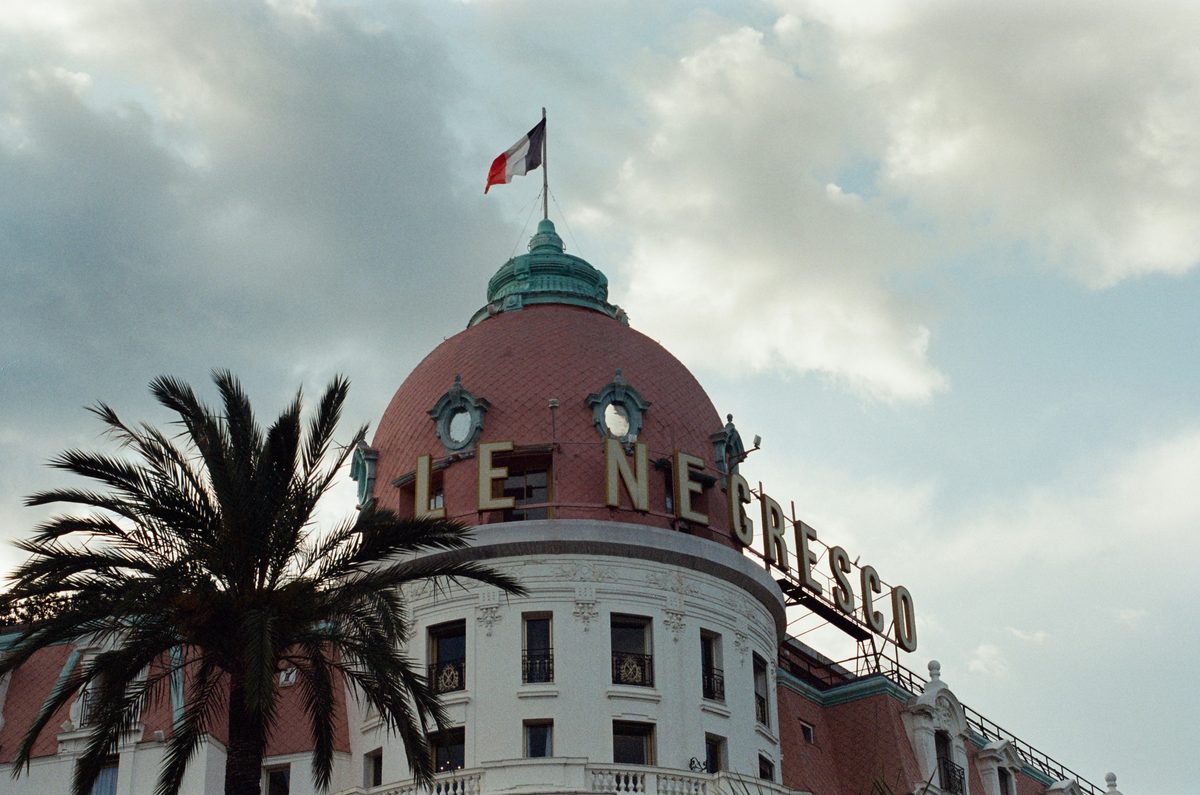 Pink dome of the Hôtel Negresco on the Promenade des Anglais in Nice with French flag
